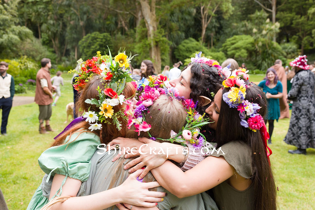 Bridal party and bride all hugging together.